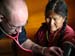 China Cal Intern and UCI student Mike Gragnani examines patient in La Ba village